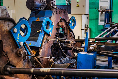 Machine for induction heating of metal. A metal rod heated in an induction furnace. Hot metal processing. Metalworking in the industrial workshop at the factoryの写真素材
