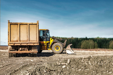 Powerful wheel loader or bulldozer working on a quarry or construction site. earthworks in...
