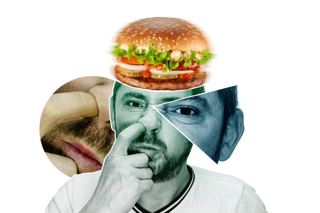The man picks his nose isolated on white background. Dreams of food. Close-up of a man with a finger in his nose. autism. hygiene. bad habitの写真素材