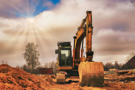 Excavator on earthworks at construction site. Backhoe on foundation work and road construction....