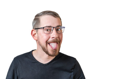 Portrait of an attractive bearded man of European appearance, with a slight gray hair, on an isolated white background. Show language. Expression of emotions of a manの写真素材