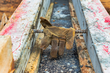 Leather construction gloves on the concrete surface of the foundation. Old worker's gloves on a vintage background. Remedy protection.の写真素材
