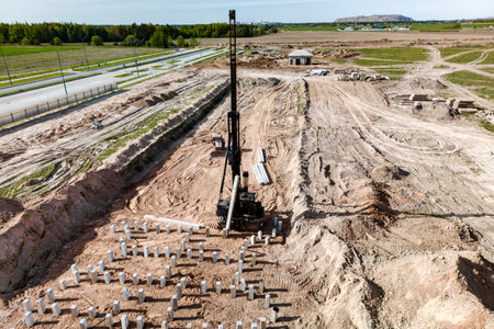 Pile driving machine. Diesel hammer pile driving machine working on construction site. Preparation of the pile foundation for the construction of the buildingの写真素材