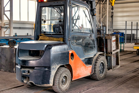 Forklift in a modern automatic warehouse or factory. Moving heavy loads in the enterprise....