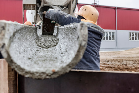 Mixer truck is transport concrete to the casting place on building site, Selective focus. Concrete is flowing into the foundations of the building. Monolithic concrete worksの写真素材