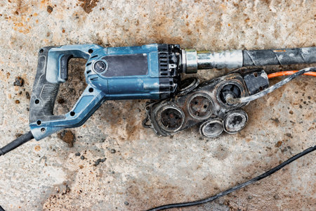 Manual electric vibrator for concrete pouring work. Using a concrete vibrator to compact hard concrete. close-up. Compaction of concrete in the foundationの写真素材