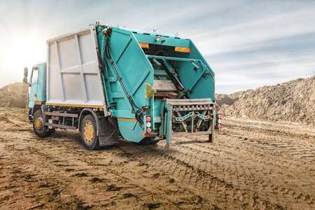 A large garbage truck brought the garbage to the quarry for temporary storage. Powerful modern...