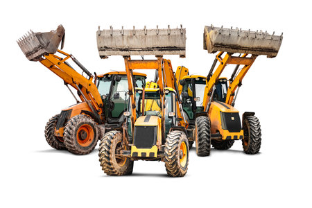 Three heavy wheeled front loaders or bulldozers on a white isolated background. Construction equipment and transport. Rental of construction equipment. Close-up. excavation. element for designの写真素材
