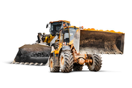 Two heavy wheeled front loaders or bulldozers on a white isolated background. Construction equipment and transport. Rental of construction equipment. Close-up. excavation. element for designの写真素材