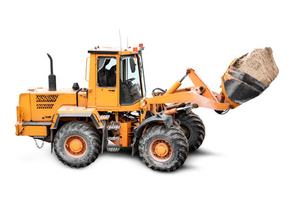 Heavy front loader or bulldozer on a white isolated background. construction machinery. Transportation and movement of bulk materials. Large bucket for earth, sand and gravelの写真素材