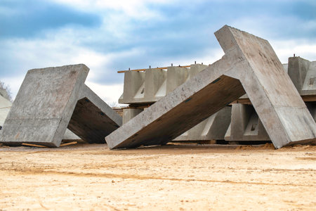 Large reinforced concrete structures at the construction site. Preparation for the installation of reinforced concrete products. Construction work on the construction of foundationsの写真素材