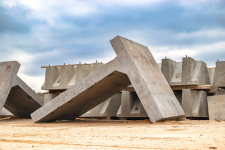 Large reinforced concrete structures at the construction site. Preparation for the installation of reinforced concrete products. Construction work on the construction of foundationsの写真素材