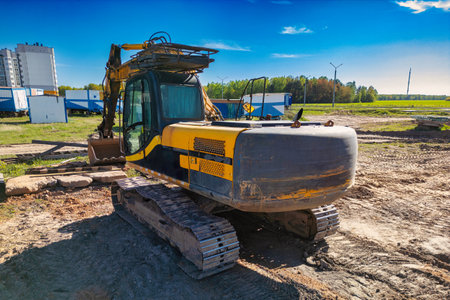 Crawler Excavator Machine Unloading Sand or Soil at Construction Area Background. Close-up of a powerful excavator. Rental of construction equipment. Earthworks contractorの写真素材