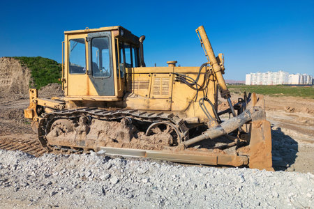 Bulldozer during the construction of a new road. Top view of a powerful working bulldozer. Earthmoving equipment for road works, land clearing, leveling, trenchingの写真素材