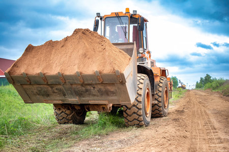 A substantial amount of dirt sitting on the side of a rural dirt road. loader.の写真素材