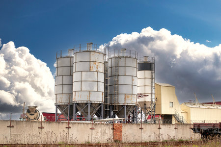 A factory releasing large amounts of smoke into the air, creating pollution and affecting the environment.の写真素材