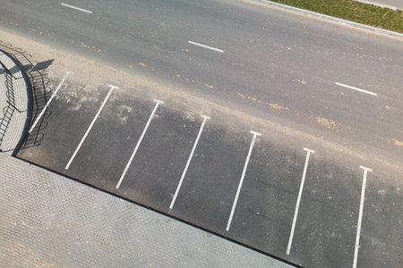A mesmerizing aerial view showcases a parking lot below, dotted with parking meters standing tall and elegant.の写真素材
