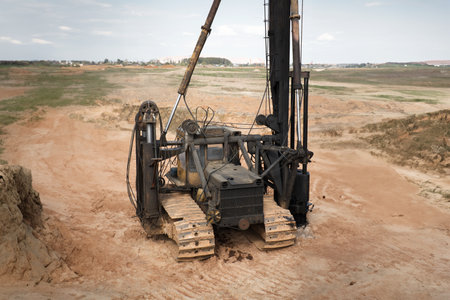 Pile driving machine. Diesel hammer pile driving machine working on construction site. Preparation of the pile foundation for the construction of the building. Close-upの写真素材