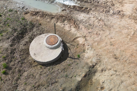 A cement bowl sits abandoned on the ground, weathered and worn but still retaining its simple elegance and strength.の写真素材