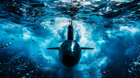 A submarine ascends from the depths, its sleek form breaking the surface of the ocean.の素材