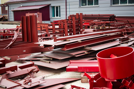 Metal structures are organized on the grounds of an industrial site, showing an array of steel components and materials awaiting installation.の写真素材
