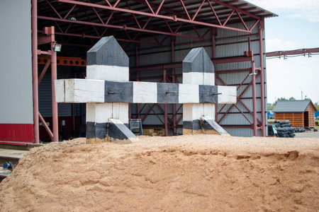 A railway dead-end features specialized braking devices designed for emergency situations, surrounded by a sandy barrier at an industrial facility.の写真素材