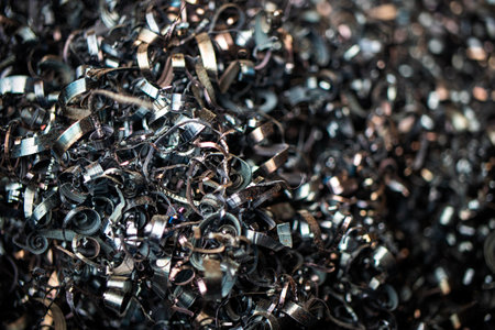 Metal filings accumulated during machining processes are prepared for recycling at a manufacturing site, promoting sustainability and resource efficiency.の写真素材