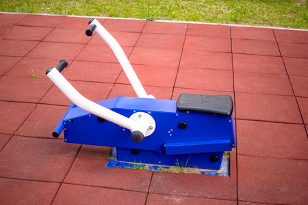 The courtyard features modern exercise machines designed for residents to engage in outdoor fitness...