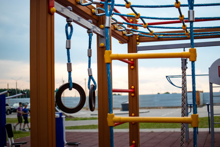 Kids enjoy climbing, swinging, and exploring various play structures in a vibrant playground by the...