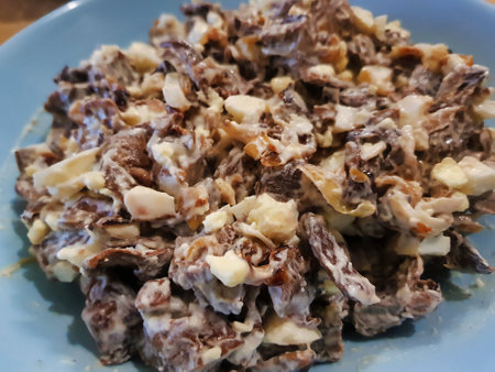 A flavorful blend of tender meat, creamy dressing, and crunchy nuts creates a delightful salad perfect for casual gatherings or festive occasions.の写真素材