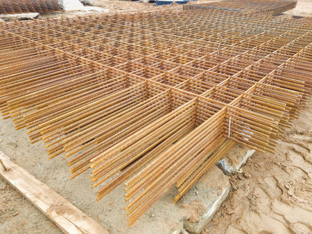 Steel rebars are meticulously organized in a rectangular grid, awaiting placement for a concrete...