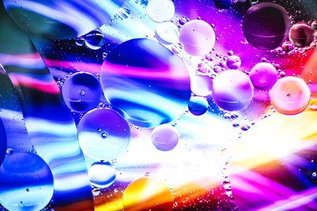 Under a microscope, colorful bubbles and flowing patterns create a mesmerizing abstract display, inviting viewers to explore the hidden beauty of tiny elements.の写真素材