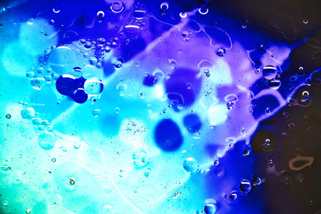 Exploring the mesmerizing world beneath the microscope, vibrant colors and intricate textures blend, offering a visual symphony of blue and purple hues.の写真素材