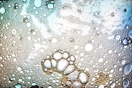 A captivating view reveals intricate, vibrant patterns created by clusters of bubbles, showing unique textures and colors under a microscope, evocative creativity.の写真素材