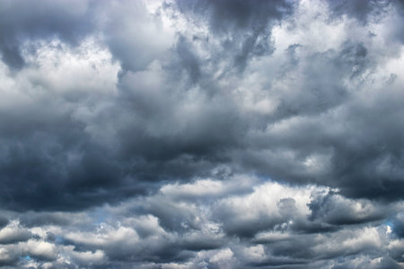 Dark clouds gather ominously overhead, hinting at an impending storm while sunlight softly pierces...