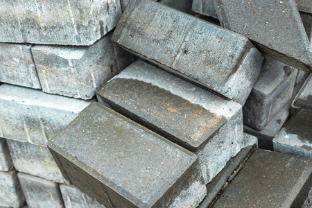 These robust concrete bricks are stacked neatly at a building site, prepared for construction work in bright daylight.の写真素材