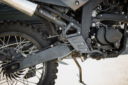 Close-up view of a motorcycle's intricate engine and frame parts, highlighting metal textures and...