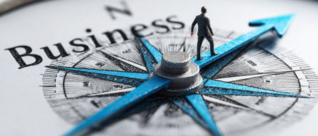 A top view captures a compass directing towards business, featuring a man walking along a blue arrow.の素材