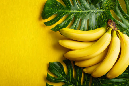 A stunning display of ripe yellow bananas nestled among lush tropical leaves, creating a vibrant and cheerful atmosphere perfect for creative projects or designs.の素材