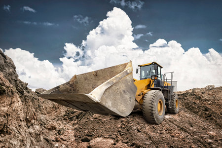 A bulldozer moves earth at a construction site, showcasing its powerful stance against a backdrop of...