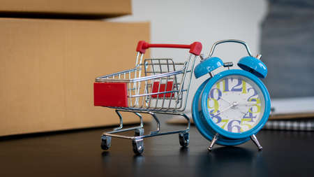 Clocks, table baskets and shopping carts on the deskの写真素材
