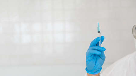 Vaccine needle in the hands of a scientist doctor for virus infection with white background