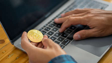 Bitcoin BTC Cryptocurrency Stock market concept BTC is USD in the hands of a businessman working on...
