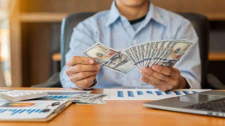 Business people count money at work. Men make money easily. Successful business people rejoice at...