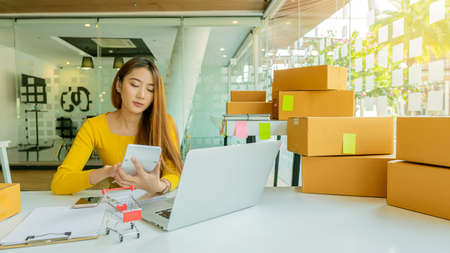 Startup Small Business Independent SME Entrepreneur Asian Young Woman Work At Home Box Smartphone...