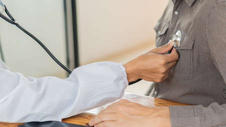 Doctors check the patient's heart pulse with a mental health care concept implant by consulting a doctor in a health check-up clinic or hospital.の写真素材