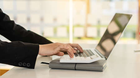 Accountants work with computers and calculators in the office.