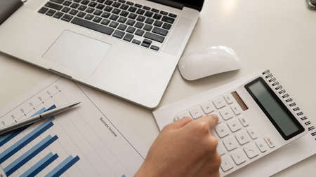 Business people work in the office with laptop data analysis graph documents on their desks