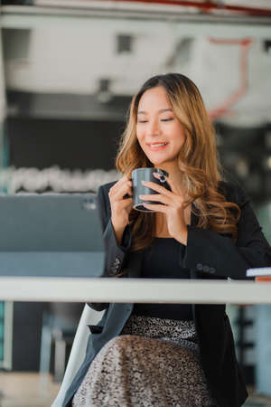 Portrait of smiling Asian businesswoman working in modern desk using tablet, freelance staff, online...