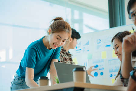 Young business finance teams in Asia work together in project brainstorming sessions. plan a strategy small start up company or office collaboration ideasの写真素材